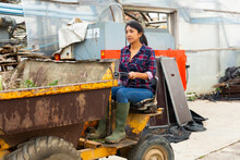Latin American Woman Farmer Working At A Company Driving A Mini Dump Truck Takes Out To Throw Out Weeds.