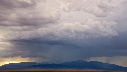 Wall Mural - Timelapse of rain storm moving over the desert mountains in Utah during summer monsoon season.