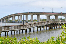 Causeway Bridge Over The Halifax River With Wooden Pier In The Foreground In Downtown Daytona Beach Florida