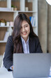 © ArLawKa - Asian businesswoman analyzing investment chart with laptop financial accounting concept in the office