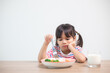 © FAMILY STOCK - Nutrition & healthy eating habits for kids concept. Children do not like to eat vegetables. Little cute girl refuses to eat healthy vegetables.