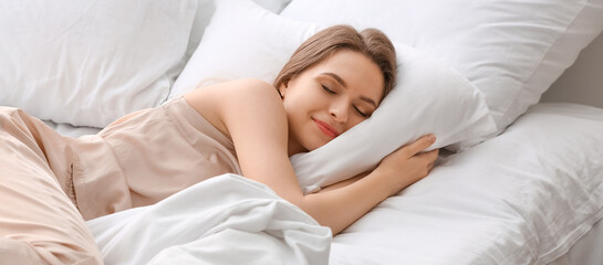 Wall Mural - Beautiful young woman sleeping in bed