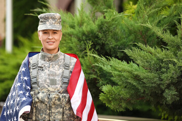 Wall Mural - Mature female soldier with USA flag outdoors