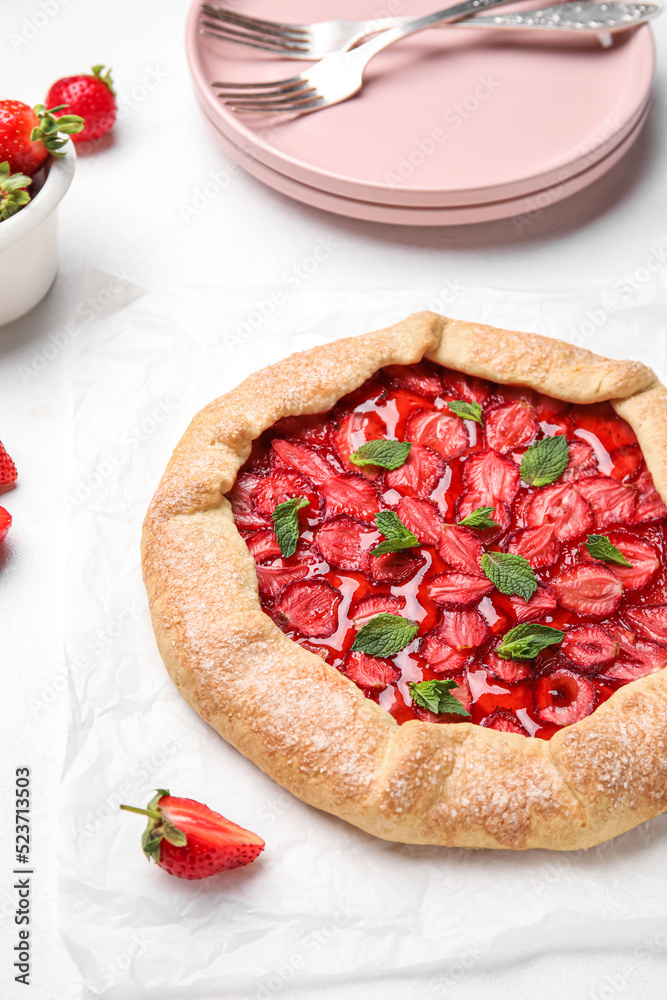 Delicious strawberry galette on light background