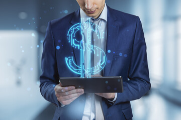 Poster - businessman hands holding and pointing at digital pad with abstract glowing blue circuit dollar hologram on blurry bokeh office interior background. Online banking and financial technology concept. 
