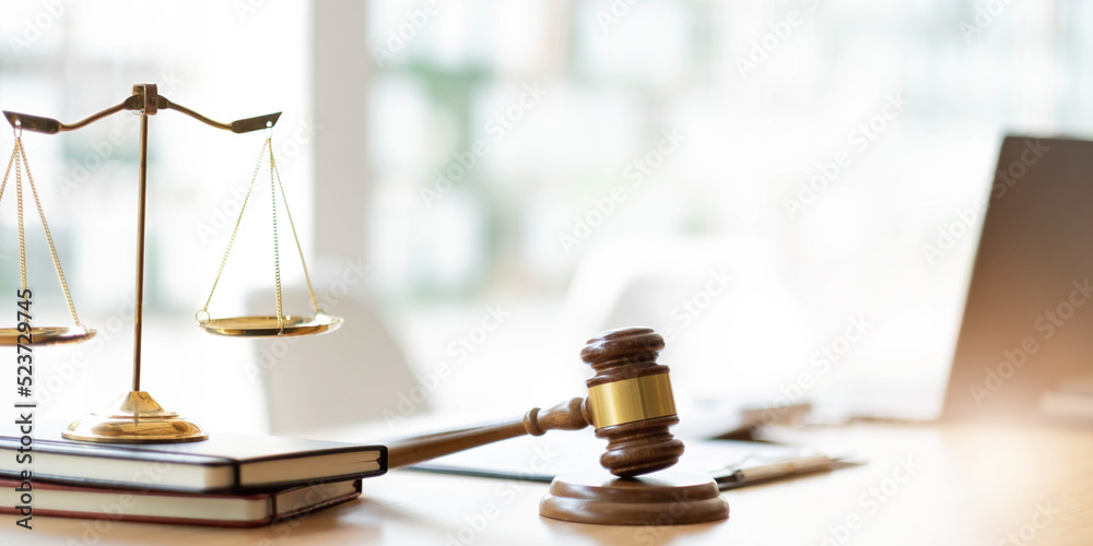 Business and lawyers discussing contract papers with brass scale on desk in office. Law, legal services, advice, justice and law concept picture with film grain effect