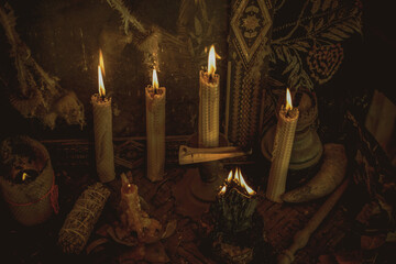 Candle burns on the altar, magic among candles, clean negative energy, wicca concept