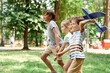© gpointstudio - Group of kids playing together with airplane toy