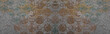Old brown gray rusty vintage worn shabby patchwork motif tiles stone concrete cement wall texture background banner panorama wide pattern