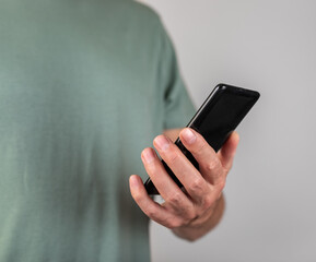 Poster - Man hand holding phone. Male looking at smartphone screen for checking notification, message, answering call. Using telephone in modern life. High quality photo