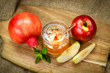 Wall Mural - Rosh Hashanah. Pomegranate, apple and honey, traditional food for Jewish New Year celebration, Rosh Hashanah. View from above.