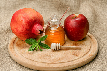 Wall Mural - Rosh Hashanah. Pomegranate, apple and honey, traditional food for Jewish New Year celebration, Rosh Hashanah.