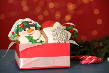 Wall Mural - Sweet Christmas cookies on table against blurred festive lights