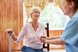 © Robert Kneschke - Elderly nurse holds hands of senior woman with crutch