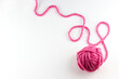 © rashevskiy - Top view of pink yarn ball with woolen thread on white background