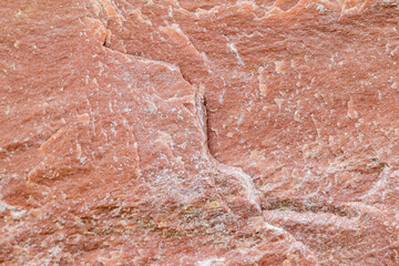 texture of a stone wall with cracks and scratches which can be used as a backgr. texture of red ston