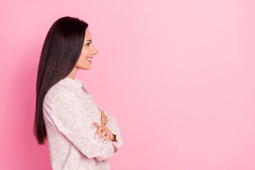 Wall Mural - Profile photo of young attractive pretty woman smiling wear shirt folded arms looking empty space isolated on pink color background