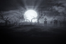 Spooky Halloween Night With Moon Rising In Old Graveyard