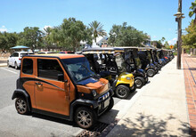 Line Of Golf Carts Parked In Sumter Landing, The Villages, Florida, USA.