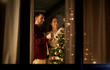 © Syda Productions - winter holidays and people concept - happy couple decorating christmas tree at home