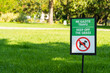 a rectangular sign prohibiting the walking of dogs and other animals on the lawn of a public park, Signs with information.