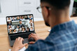 © Kateryna - Over shoulder view at a laptop screen with different people, employees, business partners, male conducts online briefing, brainstorming, group conversation. Online video communication concept