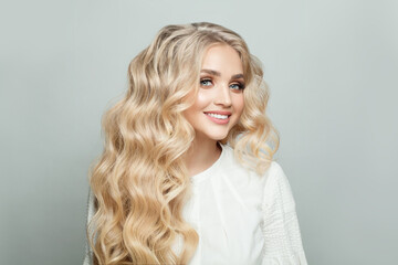 Wall Mural - Portrait of attractive woman with long healthy perfect wavy hair against white background