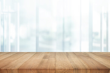 Wall Mural - Selective focus.Top of wood  table with window glass and cityscape background