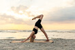 Leinwandbild Motiv fitness, sport, and healthy lifestyle concept - woman doing yoga downward facing dog pose on beach over sunset