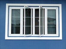 White Window House And Blue Wall