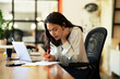 © JustLife - Happy businesswoman working on laptop. Portrait of beautiful businesswoman in the office..