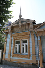 Wall Mural - Vintage wooden rural house with ornamental windows, carved frames in Ryazan city, Russia. Old traditional national architecture of Ryazan. Folk style. Ryazan landmark