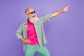 Poster - Portrait of excited cheerful aged man indicate finger empty space blank isolated on purple color background