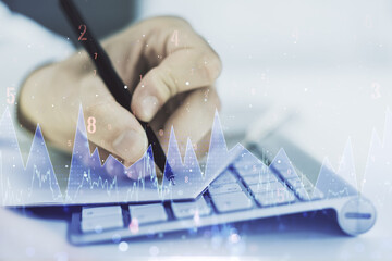 Fototapete - Double exposure of abstract creative statistics data hologram with hand writing in notebook on background with laptop, statistics and analytics concept