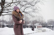 © alexkich - A young girl in a winter park on a walk. Christmas holidays in the winter forest. The girl enjoys winter in the park.