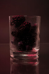 Wall Mural - Berries in a glass. Blackberries and blueberries in a bowl on a dark background