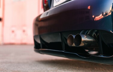 Canvas Print - Twin tip exhaust pipe coming through the rear diffuser on the back of a car