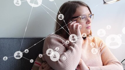 Poster - Animation of profile icons connecting with lines over young caucasian woman taking on phone at home