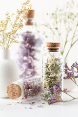 Wall Mural - Dried herbal flowers with bottle. Homeopathy background.