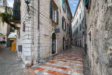 Wall Mural - A narrow tile and stone alley through the historic medieval old town at Kotor, Montenegro.