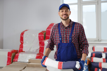 Poster - Construction worker with new building materials in room prepared for renovation