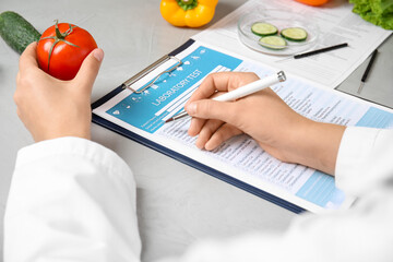 Wall Mural - scientist with laboratory test form and fresh tomato at table indoors, closeup. poison detection
