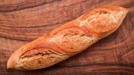 Wall Mural - Top view of fresh Baguette bread on wooden surface