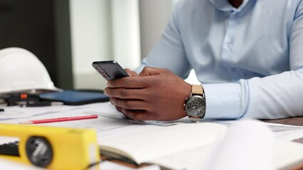 Aufkleber - Closeup of the hands of an engineer or architect on a phone typing, reading email or on social media. Focused African guy using apps on a mobile, web surfing online, and searching for information.