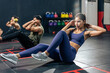 Group of fitness trainer sit-up on floor for abs workout cardio in gym