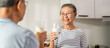 © Kawee - Asian senior elderly couple drink a glass of milk in kitchen at home.