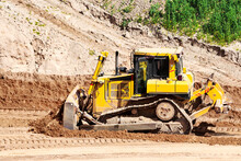 A Powerful Bulldozer In A Sand Pit Is Planning A Site. Extraction Of Sand In An Open Pit. Natural Building Materials.