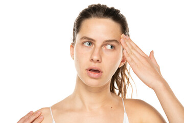 Wall Mural - Portrait of confused charming young woman touching forehead ask you to remember think isolated on white background.