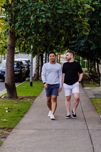 Two Men Walking On The Footpath