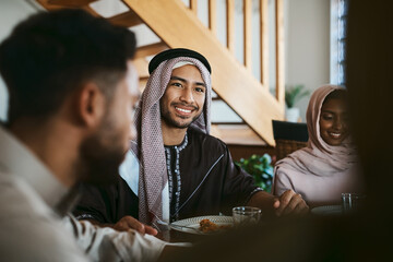 muslim, arab and islamic man enjoying a meal for eid, ramadan or breaking fast with family while cel